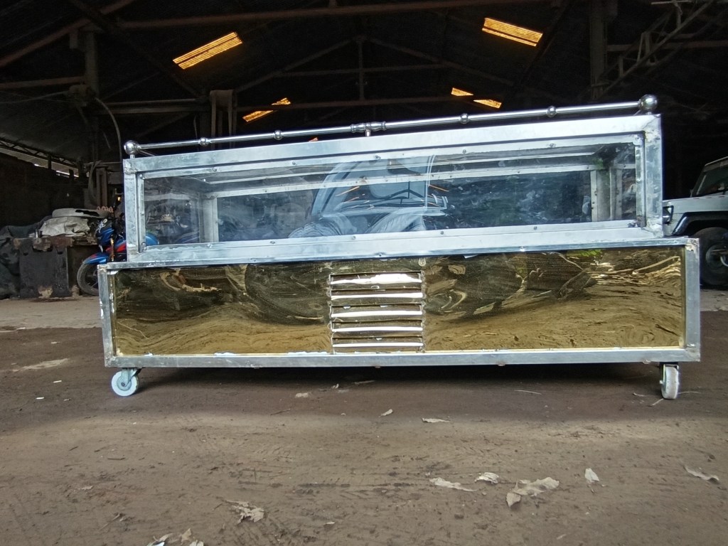 A golden color steel freezer with a transparent glass cover. This is used for dead body preservation.
